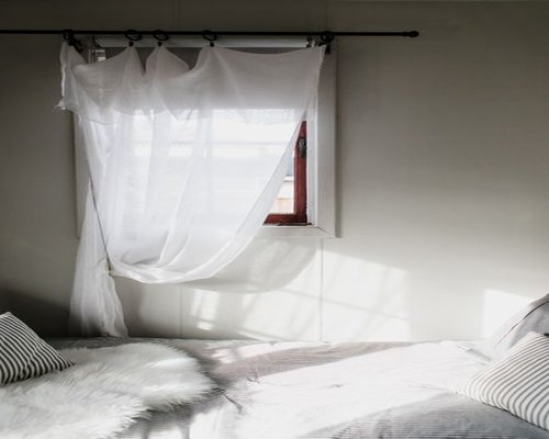 A peaceful home bedroom during weekends filled with natural light promoting absolute quiet rest